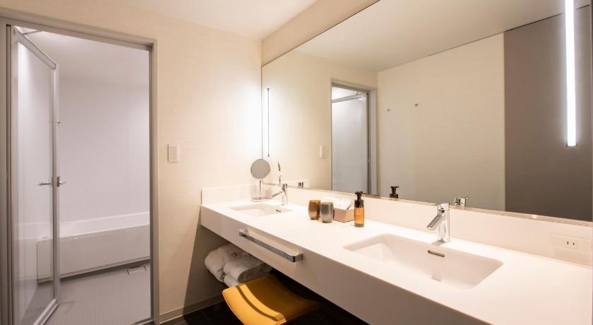 a bathroom with a tub, sink and mirror, THE GATE HOTEL RYOGOKU by HULIC in Tokyo