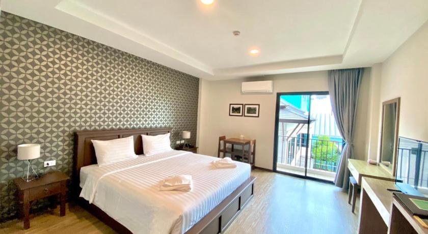 a hotel room with a bed and a television, J.P.GRAND HOTEL in Trat