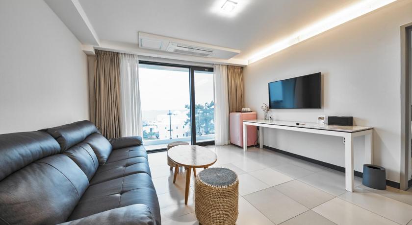 a living room filled with furniture and a tv, Lareem Boutique Hotel in Jeju