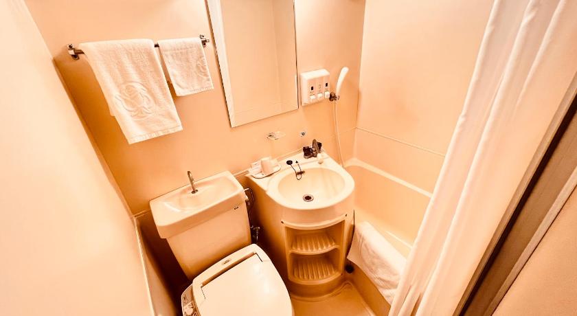 a bathroom with a toilet a sink and a bathtub, Reisenkaku Hotel Kawabata Nakasu in Fukuoka