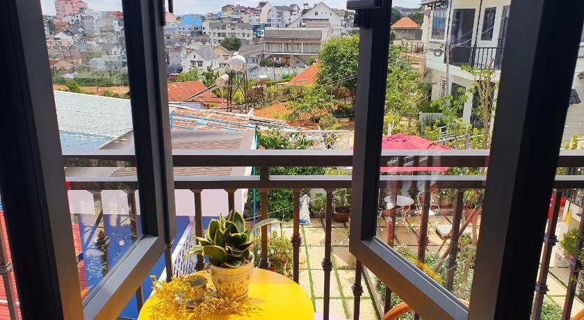 a view through a window of a garden area, Let'stay Homestay Da Lat in Dalat