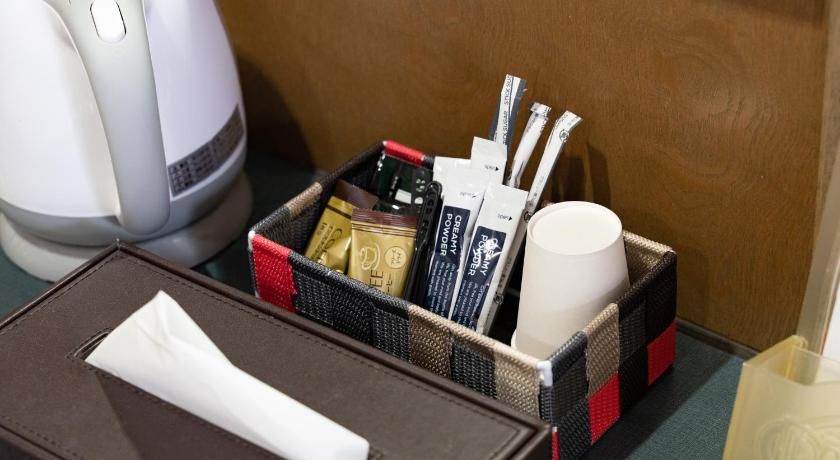 a tray with a toothbrush, toothpaste, and other items, Hotel Sun in Takasaki