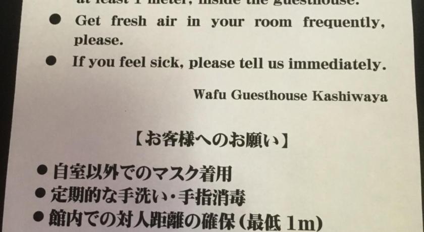 a sign that is on top of a white board, Wafu Guesthouse Kashiwaya in Fujikawaguchiko