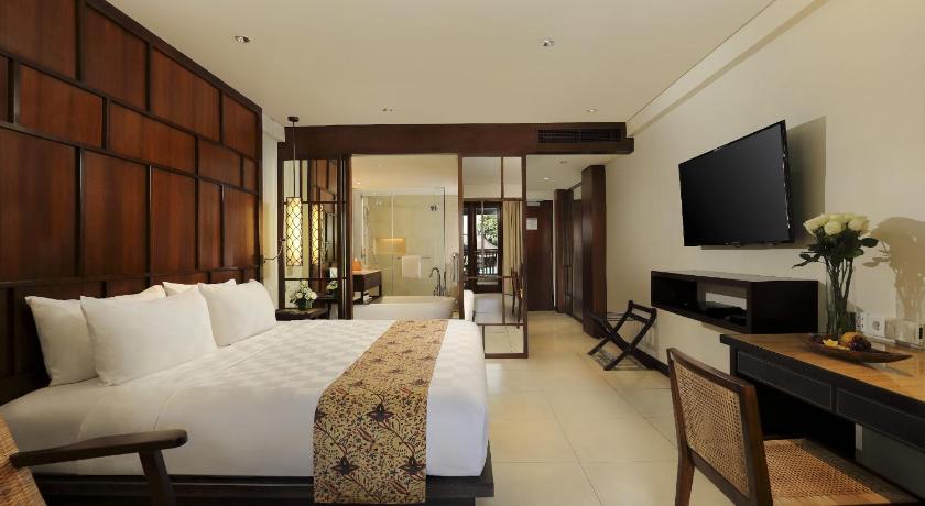 a living room with two couches and a television, Padma Resort Legian in Bali