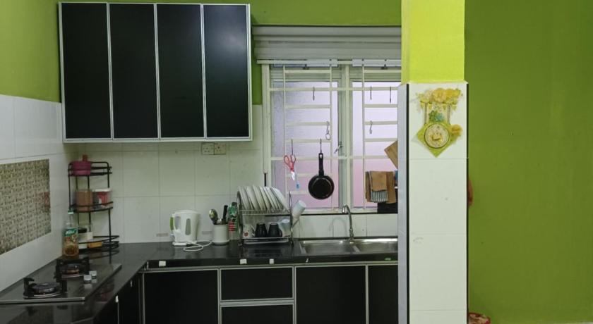 a kitchen with a stove, sink, and cabinets, Homestay Dalia, Beseri, Perlis in Kangar