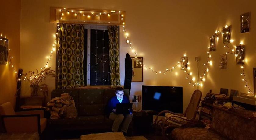 a living room filled with furniture and a christmas tree, Tirana Backpacker Hostel in Tirana