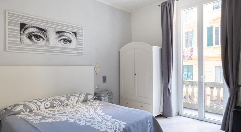 a bedroom with a bed and a window, Affittacamere Golfo Della Luna in La Spezia