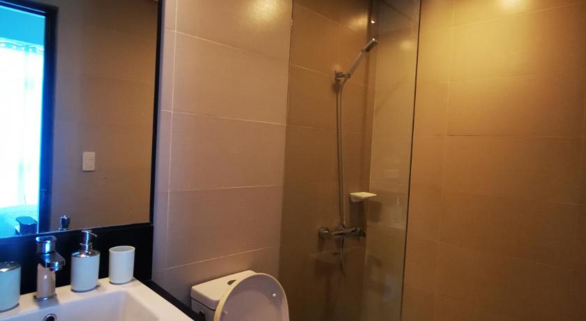 a bathroom with a toilet a sink and a shower, New Paradise Ocean View Apartment (DOT accredited) in Boracay Island
