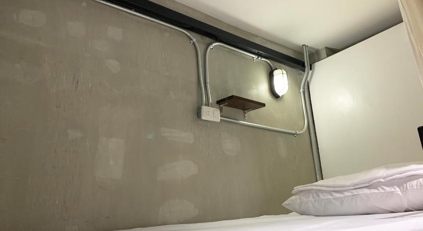 a bedroom with a mirror and a bed, HappyNest Hostel Cebu in Cebu