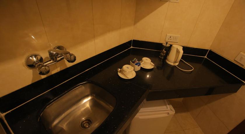a sink and a toilet in a bathroom, Hotel The Royal Plaza in New Delhi and NCR