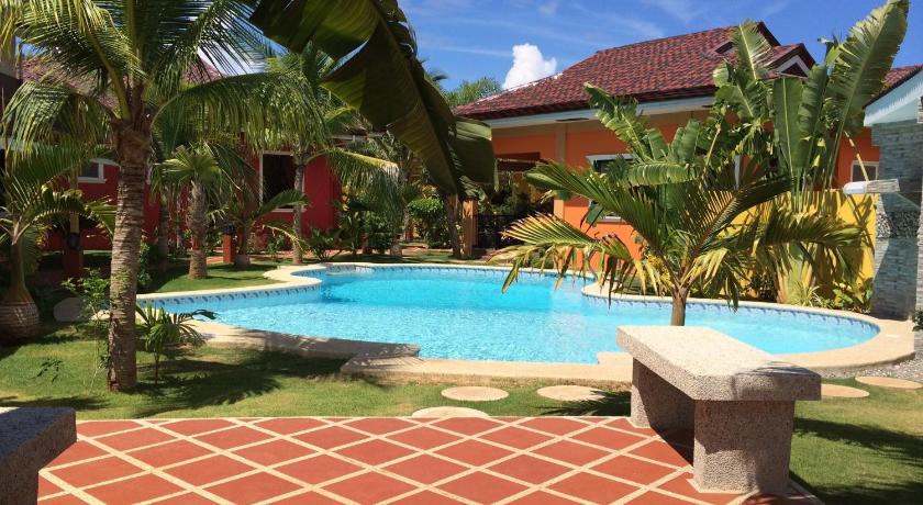 a patio with a pool and a pool table, Alona Garden Hotel in Bohol