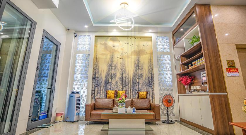 a living room filled with furniture and a painting on the wall, GOLD CITY Hotel in Tay Ninh