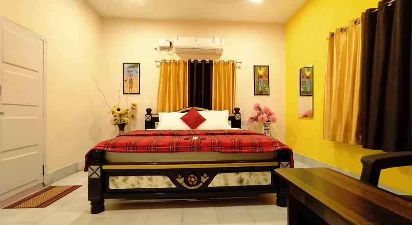 a bedroom with a red bed and a red dresser, Kushi HomeStay Guest House in Visakhapatnam