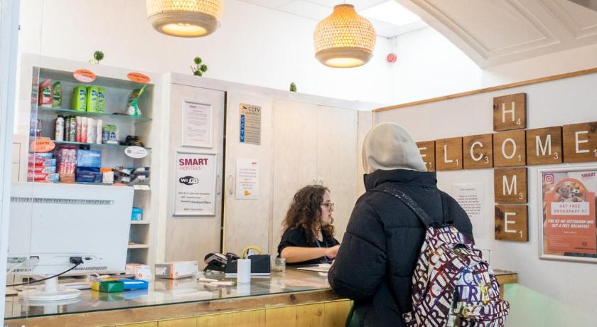 a woman standing in front of a counter in a kitchen, Smart Russell Square Hostel in London