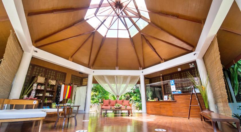 a room with a table and chairs and a large window, Mandala Villas and Spa in Boracay Island
