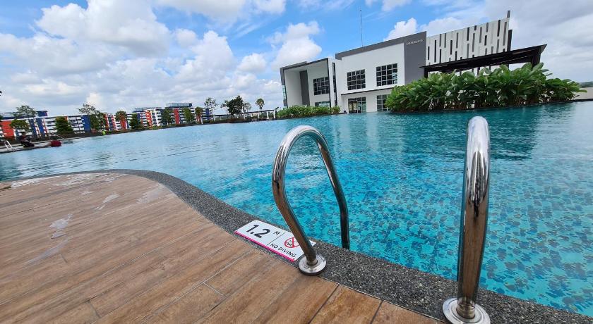 a surfboard sits on the edge of a pool, Eid SKS Habitat -Free Wifi Netflix, Larkin, Johor Bahru in Johor Bahru