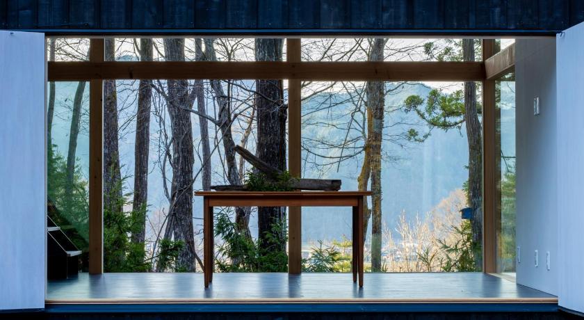 a room with a wooden table and a window, Auberge Hidanomori in Takayama