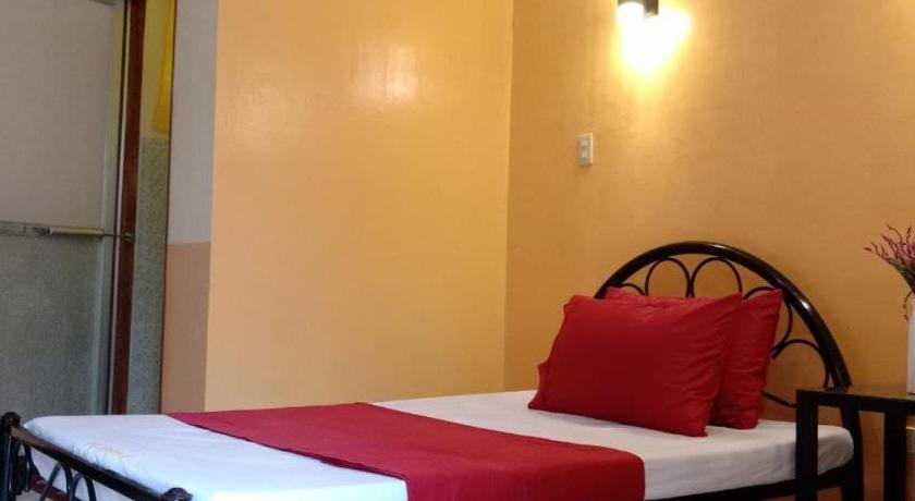 a bedroom with a large bed and a large window, RedDoorz @ Solid Rock Guest House Baler in Dipaculao