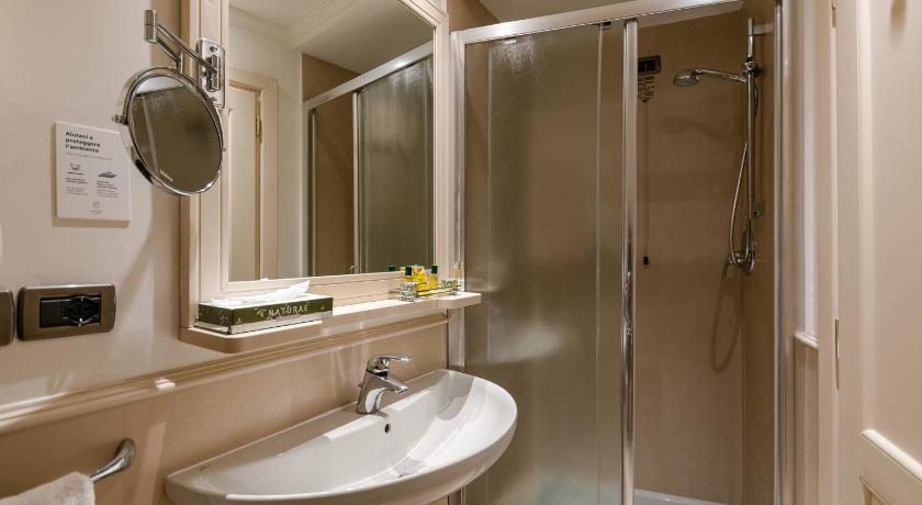 a bathroom with a shower, sink, and mirror, B&B Hotel Firenze Laurus al Duomo in Florence