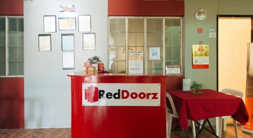 a red and white sign on a red table, RedDoorz @ FDB Homes Nueva Ecija in San Jose (Nueva Ecija)