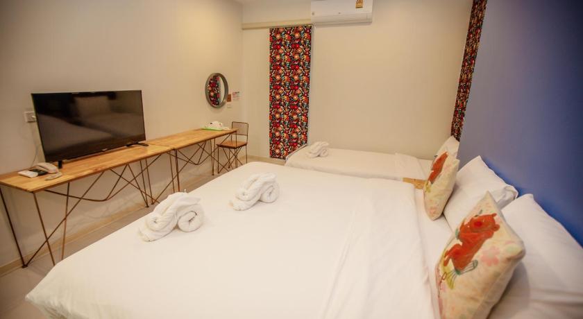 a hotel room with two beds and a television, iRabbit Hotel in Prachinburi