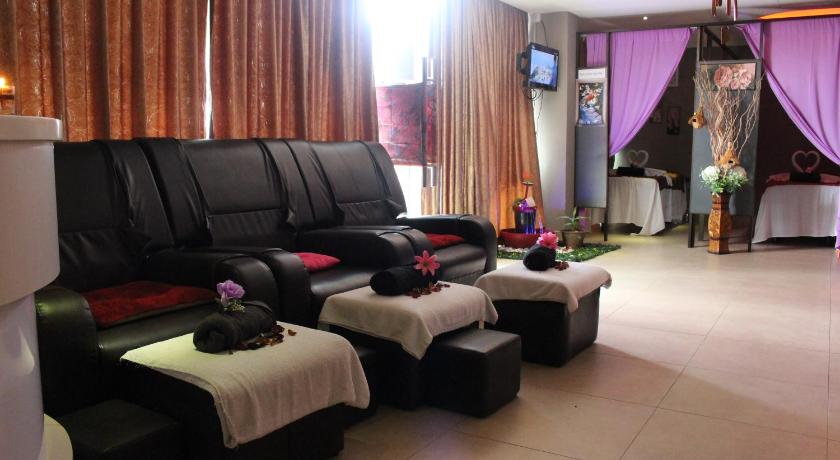 a living room filled with furniture and a couch, Paradise Spa Hotel in Port Dickson