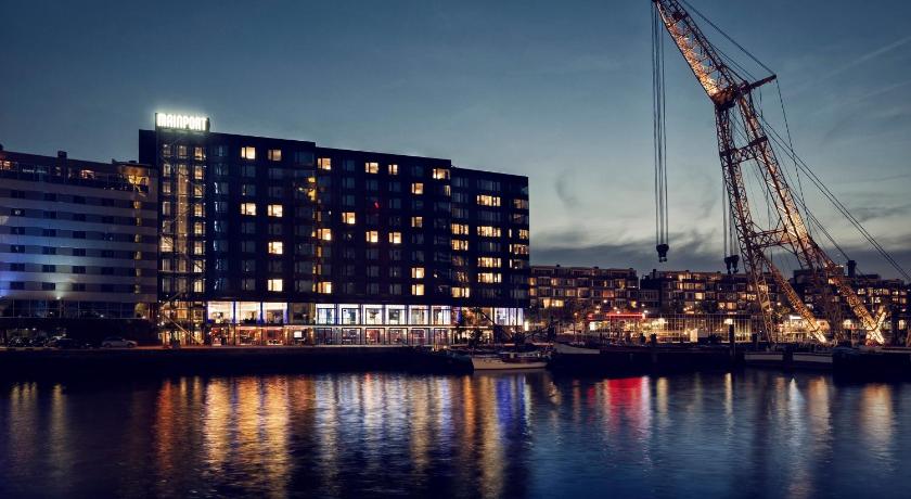a large body of water with a large building, Mainport Design Hotel in Rotterdam