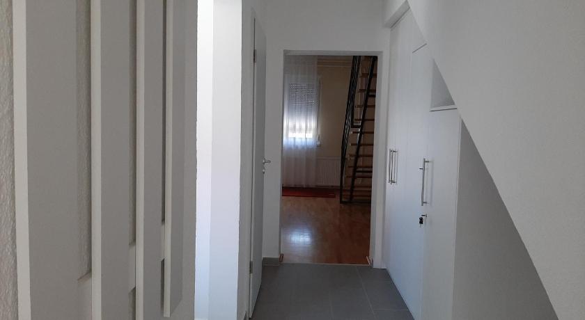 a room with a door leading to a hallway, Pelso Apartmanhaz in Keszthely