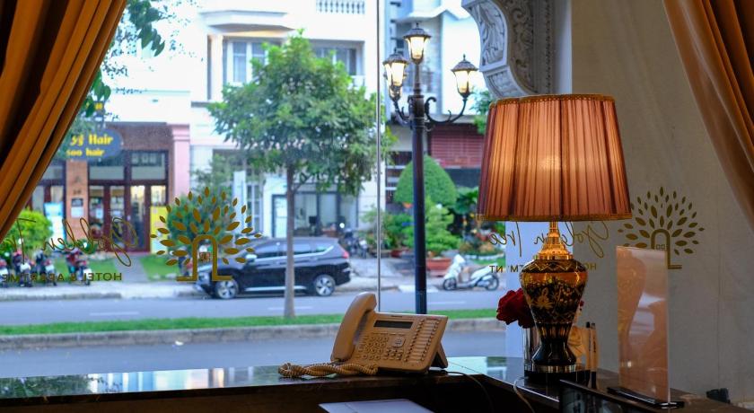 a living room with a lamp and a window, Golden Tree Hotel & Apartment in Ho Chi Minh City