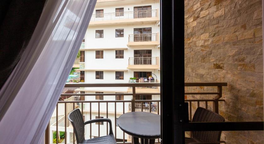 a patio area with a table, chairs, and a window, Experience Baguio Local Vibe with Free Parking Wifi Heating in Baguio