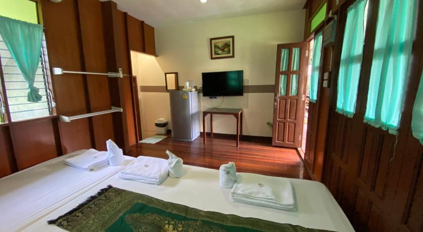a room with a bed, table, and television in it, Baan Kornnara Resort in Amphawa (Samut Songkhram)