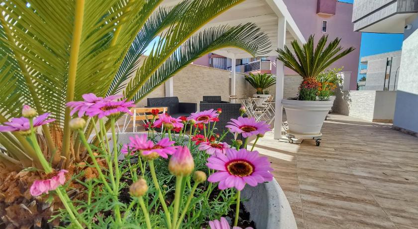a garden filled with lots of flowers next to a building, Suite 5 Monopoli in Monopoli