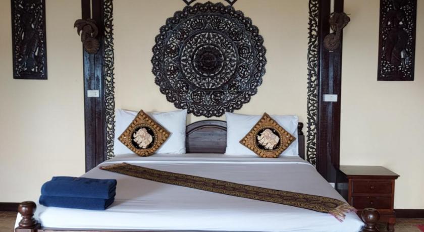 a large bed with a large wooden headboard, Paradise Pearl Bungalow in Ko Phi Phi