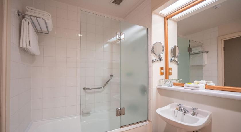 a bathroom with a shower, toilet, sink and tub, Scenic Hotel Southern Cross in Dunedin
