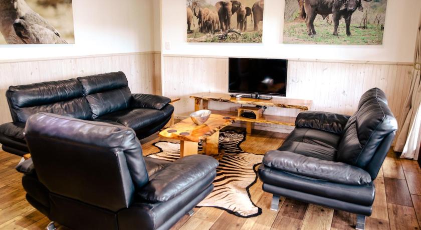 a living room filled with furniture and a tv, Monzi Safari Lodge in Monzi SH