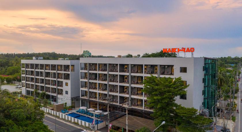 a large building with a clock on top of it, Maikhao Hotel managed by Centara (SHA Extra Plus) in Phuket