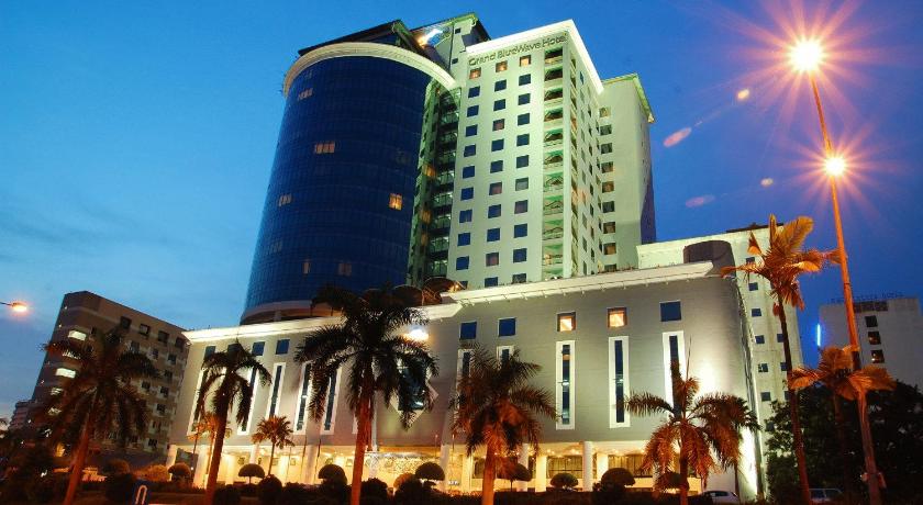 a large building with a large clock on the side of it, GBW Hotel in Johor Bahru