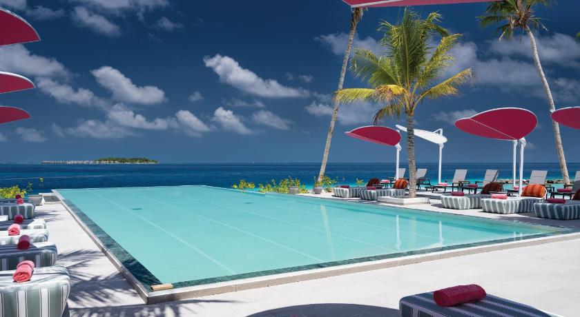 a beach area with chairs, tables and umbrellas, OBLU SELECT Lobigili - Premium All-Inclusive with Free Transfers in Maldive Islands