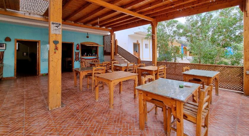a patio area with tables, chairs, and tables, Jowhara Hotel in Dahab