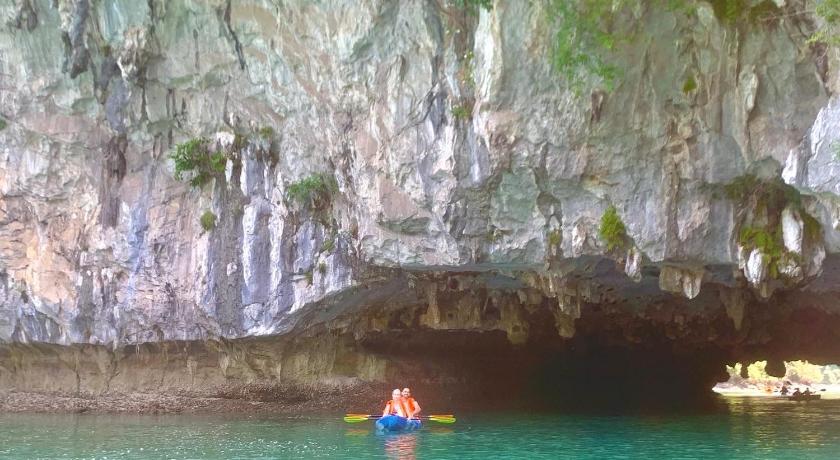 two people are in the water near a large body of water, Viet Hai Lan Homestay in Cat Ba Island