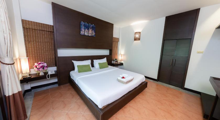 a hotel room with a bed and a dresser, River Kwai Bridge Resort (SHA Extra plus) in Kanchanaburi