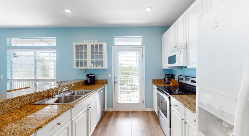 a kitchen with a sink, stove, and refrigerator, Plantation Place #h403 in Gulf Shores (AL)