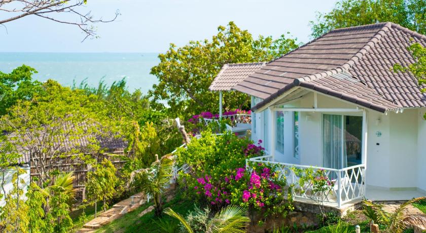a house with a balcony overlooking the ocean, Fleur De Lys Resort & Spa Long Hai in Vung Tau