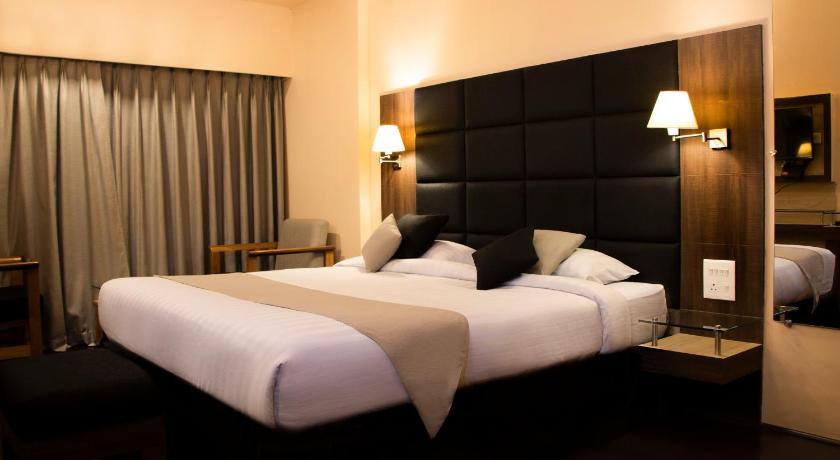 a hotel room with two beds and two lamps, Capital O 16017 Hotel Alpine Continental in Shillong