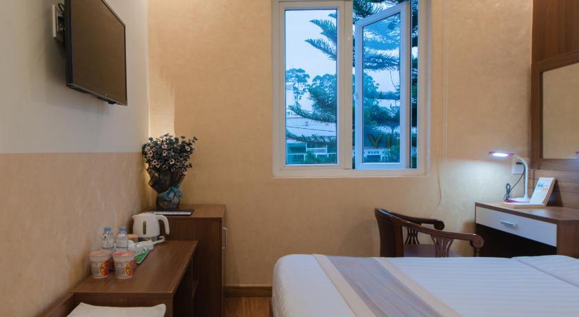 a hotel room with a bed and a window, Duy Vinh Hotel Dalat in Dalat