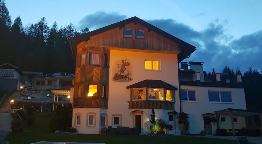 a large house with a large window, Hotel-Garni Drachenburg in Mittenwald