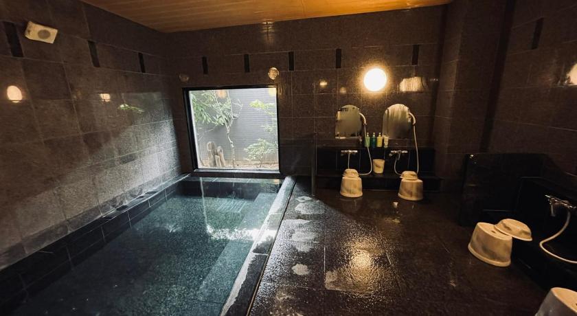 a bathroom with a tub and a bathtub, Hotel Route Inn Ichinoseki Inter in Ichinoseki