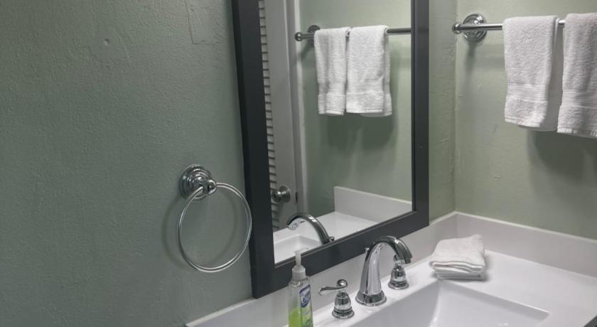 a bathroom with a sink, mirror, and towel rack, Breezy Palms Resort in Islamorada (FL)