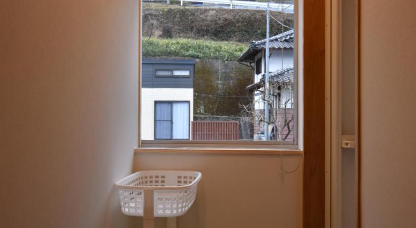 a bathroom with a sink, toilet and window, Guest House Iwato in Takachiho