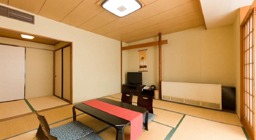 a living room filled with furniture and a tv, Livemax Resort Kawaji in Nikko